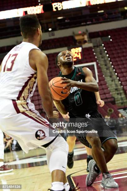 Eric Johnson guard Thomas University Night Hawks drives for the basket against Anthony Polite guard Florida State University Seminoles in an...