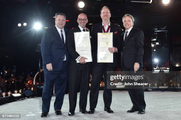 Winners of one of the 50 most performed country songs of the year for "Paracute" pose for a photo onstage during the 65th Annual BMI Country Awards...