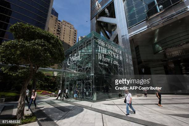 This picture taken on October 27, 2017 shows people walking in front of The Center office building in Hong Kong. Chinese investors' penchant for Hong...