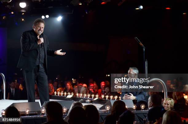 Icon Bob DiPiero speaks onstage while BMI President and CEO Mike O'Neill watches during the 65th Annual BMI Country Awards at BMI on November 7, 2017...