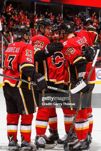 Johnny Gaudreau, Sean Monahan, Micheal Ferland and teammates celebrate in an NHL game against the Vancouver Canucks at the Scotiabank Saddledome on...