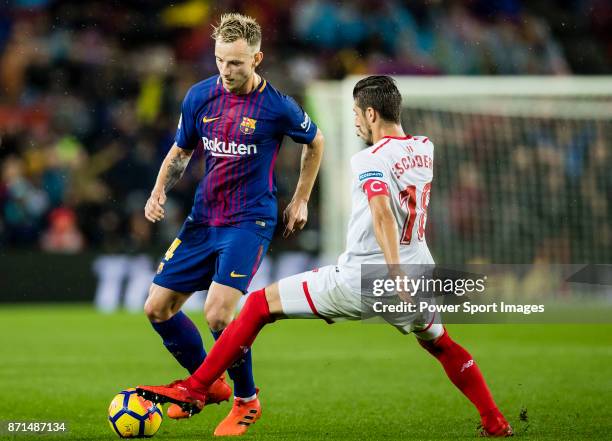 Ivan Rakitic of FC Barcelona fights for the ball with Sergio Escudero Palomo of Sevilla FC during the La Liga 2017-18 match between FC Barcelona and...