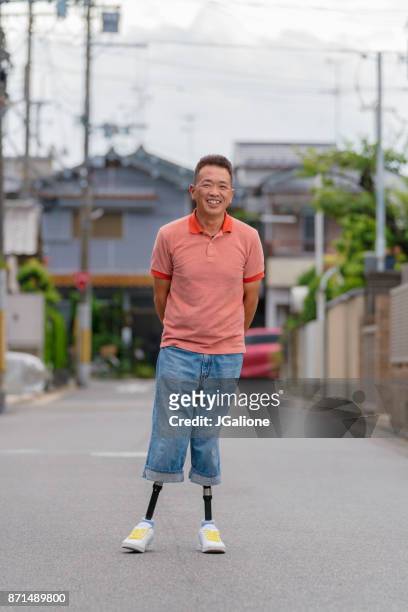 portrait of a double amputee senior man - double amputee stock pictures, royalty-free photos & images