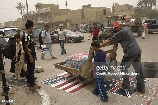 An anti-coalition slogan, "No to the occupation," is painted along with a US and British flag at a Gayara Street intersection in Sadr City, the 2.5...