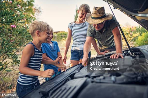 father explaining car engine to his children - dipstick stock pictures, royalty-free photos & images