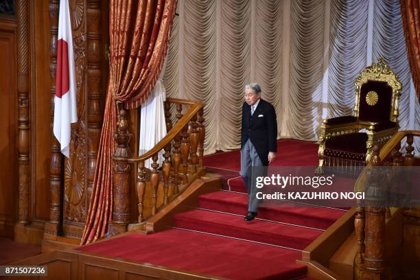 Japan's Emperor Akihito leaves following the opening ceremony of the 195th parliament session at the upper house of parliament in Tokyo on November...