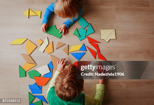 Kids playing with puzzle, education concept Kids playing with puzzle, education concept