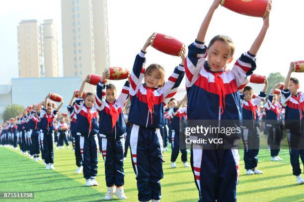 Students perform waist drums during the opening ceremony of their sports meeting at Baokang County on November 8, 2017 in Xiangyang, Hubei Province...