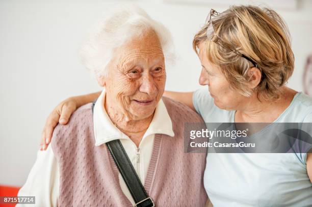 tenderness between senior mother and mature daughter - memories stock pictures, royalty-free photos & images