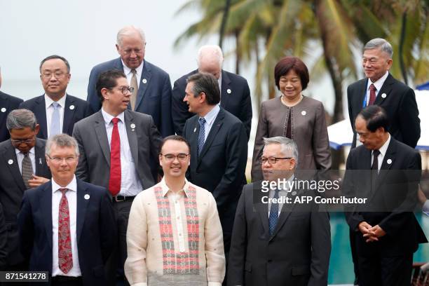 Philippine Foreign Secretary Alan Peter Cayetano poses with ministers for the "family photo" after attending the APEC Ministerial Meeting ahead of...