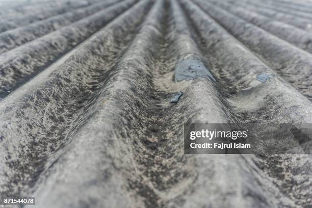 grey waved asbestos roof - asbestos stock pictures, royalty-free photos & images