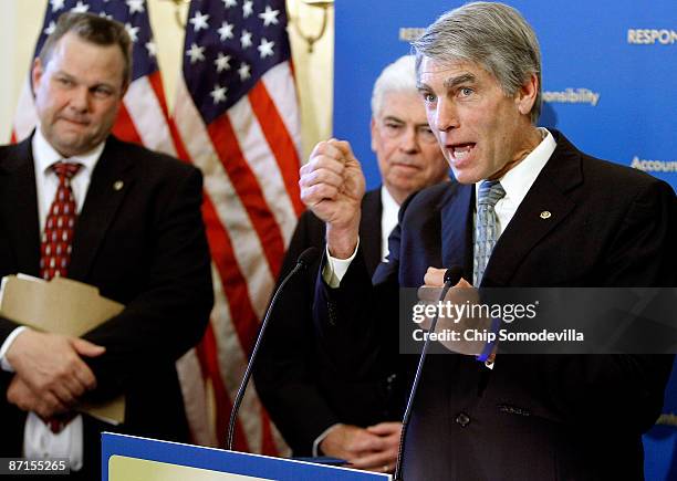 Sen. Mark Udall answers a reporter's question during a news conference with Senate Banking Committee Chairman Chrisopher Dodd and Sen. Jon Tester at...