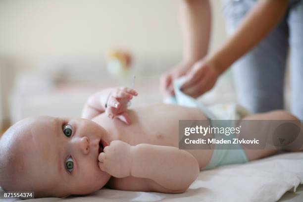 little baby boy looking at camera. - changing nappy stock pictures, royalty-free photos & images