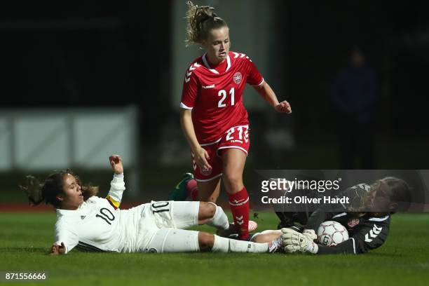 Gia Corley of Germany and Emilie Pruesse and Freja Thisgaard of Denmark compete for the ball during the U16 Girls international friendly match...