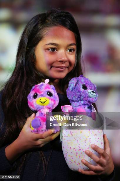 Girl holds some 'Hatchimals' while posing for a photographer during a media event announcing the top 12 toys for christmas at St Mary's Church in...