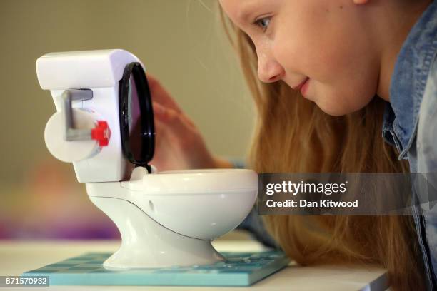 Girl plays with a 'Toilet Trouble' game during a media event announcing the top 12 toys for christmas at St Mary's Church in Marylebone on November...
