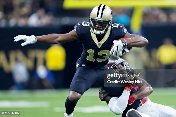 Michael Thomas of the New Orleans Saints is tackled by Robert McClain of the Tampa Bay Buccaneers at Mercedes-Benz Superdome on November 5, 2017 in...