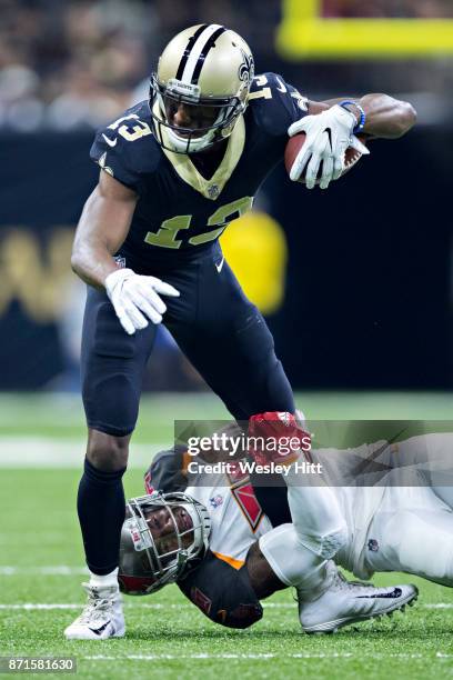 Michael Thomas of the New Orleans Saints is tackled by Robert McClain of the Tampa Bay Buccaneers at Mercedes-Benz Superdome on November 5, 2017 in...