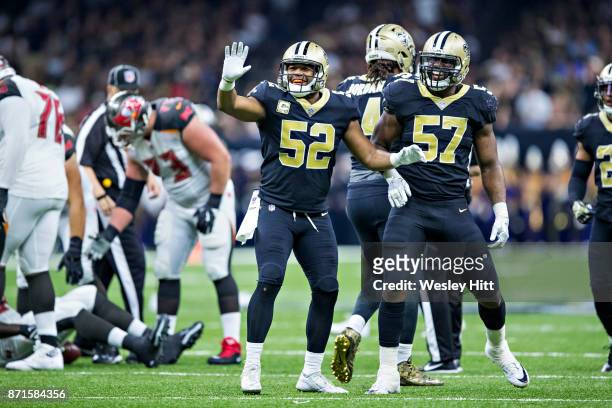 Alex Okafor and Craig Robertson of the New Orleans Saints celebrates after sacking the quarterback during a game against the Tampa Bay Buccaneers at...