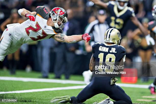 Ted Ginn Jr. #19 of the New Orleans Saints catches a touchdown pass over Chris Conte of the Tampa Bay Buccaneers at Mercedes-Benz Superdome on...