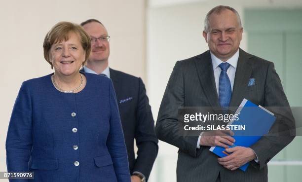 German Chancellor Angela Merkel , Christoph Schmidt , chairman of the German Council of Economic Experts on the country's economic development, and...