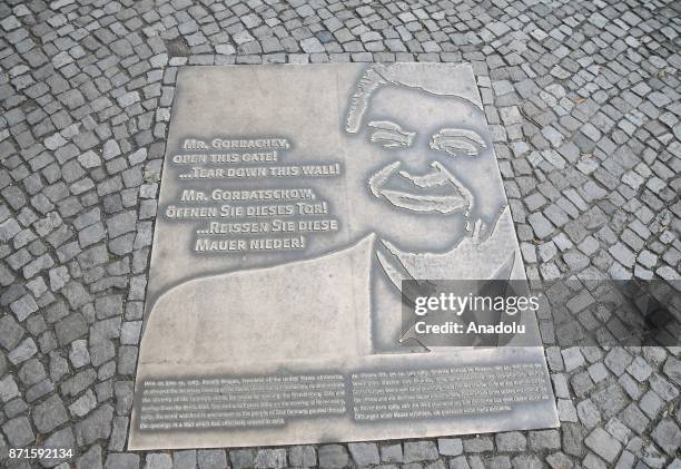 Plaque, commemorating Ronald Reagan's challenge to Mikhail Gorbachev to tear down, is seen the Berlin Wall on the 27th anniversary of the fall of the...