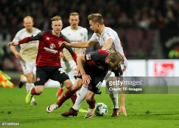 Hauke Wahl of FC Ingolstadt 04 and Hanno Behrens of 1.FC Nuernberg battle for the ball during the Second Bundesliga match between 1. FC Nuernberg and...