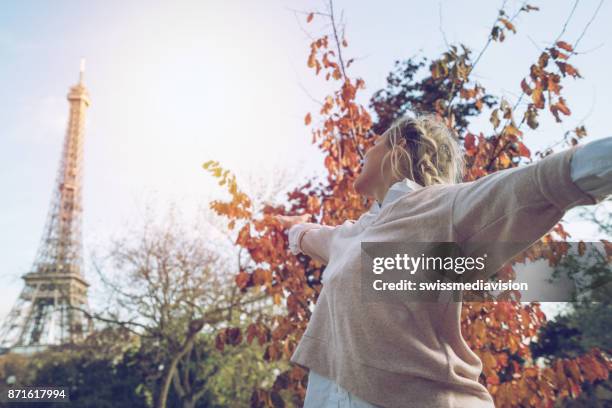 girl power, young woman arms outstretched in paris, eiffel tower - sassy paris stock pictures, royalty-free photos & images