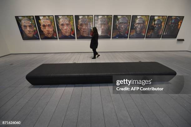 Woman looks at photographs at the Louvre Abu Dhabi Museum during a media tour on November 6, 2017 prior to the official opening of the museum on...