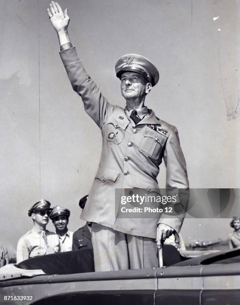 General Wainwright, standing in car, waving to crowd gathered at La Guardia field 1945. Jonathan Mayhew 'Skinny' Wainwright IV was a career American...