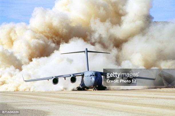 Photograph of the clouds of dust behind US Air Force C-17 Globemaster III at Fort Irwin, California. Dated 1999.