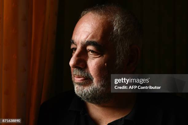 French writer Philippe Jaenada poses after he was awarded the Femina literary prize on November 8, 2017 in Paris, for his book entitled "La Serpe" ....