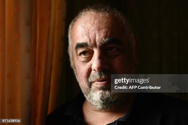 French writer Philippe Jaenada poses after he was awarded the Femina literary prize on November 8, 2017 in Paris, for his book entitled "La Serpe" ....