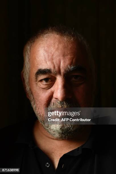 French writer Philippe Jaenada poses after he was awarded the Femina literary prize on November 8, 2017 in Paris, for his book entitled "La Serpe" ....