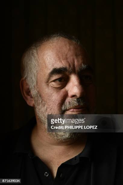 French writer Philippe Jaenada poses after he was awarded the Femina literary prize on November 8, 2017 in Paris, for his book entitled "La Serpe" .