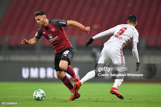 Eduard Loewen of 1.FC Nuernberg and Alfredo Morales of FC Ingolstadt 04 compete for the ball during the Second Bundesliga match between 1. FC...