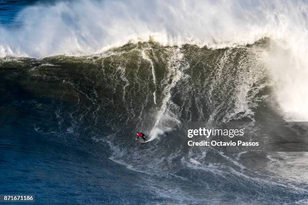 Australian big wave surfer Ross Clarke-Jones drops a wave during a surf session at Praia do Norte on November 8, 2017 in Nazare, Portugal.