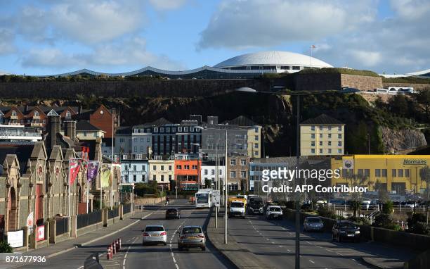 Cars travel by the seafront in St Helier, on the British island of Jersey, on November 8, 2017. Jersey is a British Crown Dependency, with a...