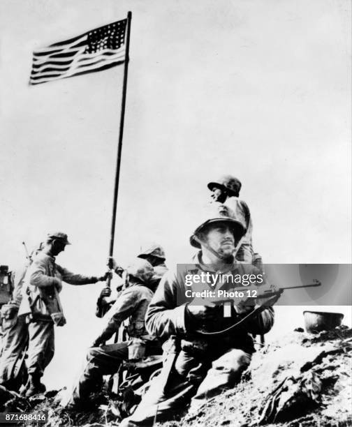 First flag set atop Mt. Suribachi, 23 February 1945, during World war Two United States Marine Corps photograph taken by Staff Sergeant Louis R....