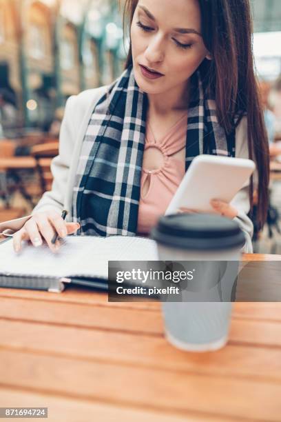 young woman writing in a textbook - calendar 2017 imagens e fotografias de stock