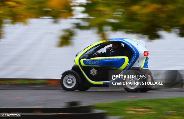 Police car run on electric energy drives along a street at the 'Bonn Zone' on November 8, 2017 during the COP23 United Nations Climate Change...