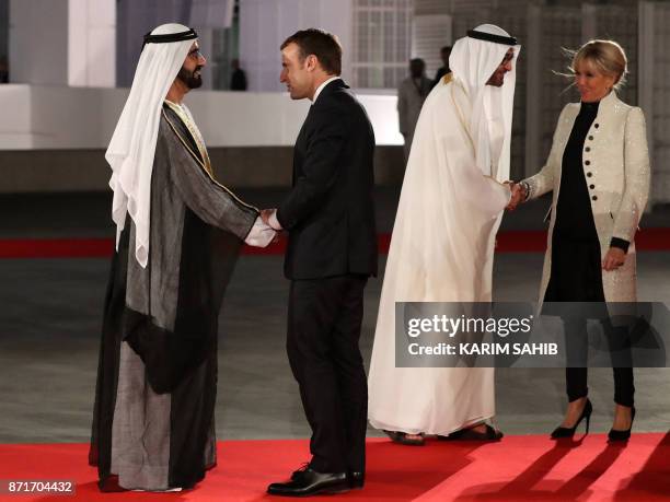 Ruler of Dubai Sheikh Mohammed bin Rashid al-Maktoum shakes hands with French President Emmanuel Macron as Abu Dhabi Crown Prince Mohammed bin Zayed...