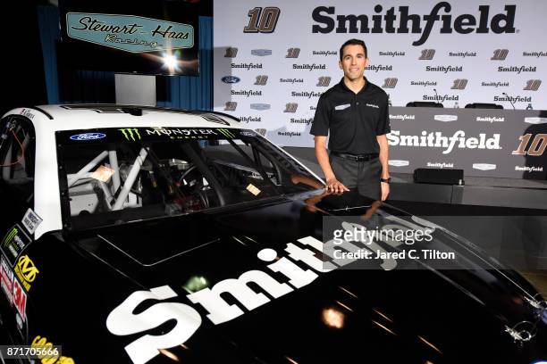 Aric Almirola poses for a photo opportunity with the Smithfield Ford during a press conference at Stewart-Haas Racing on November 8, 2017 in...
