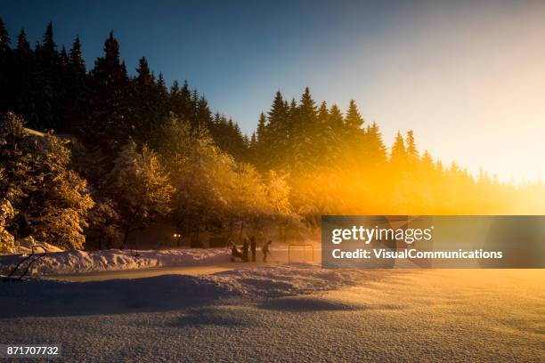 whistler, bc: pond hockey on alta lake. - outdoor ice hockey stock pictures, royalty-free photos & images