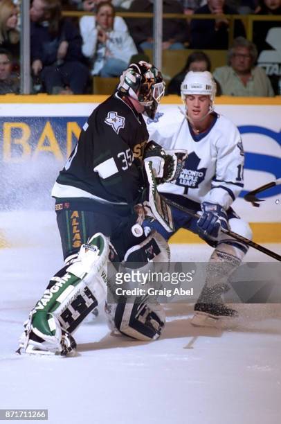 Andy Moog of the Dallas Stars skates against Darby Hendrickson of the Toronto Maple Leafs during NHL game action on March 15, 1996 at Maple Leaf...