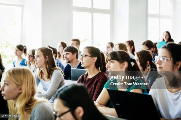 university students listening and concentrating during lecture - classroom computer stock-fotos und bilder