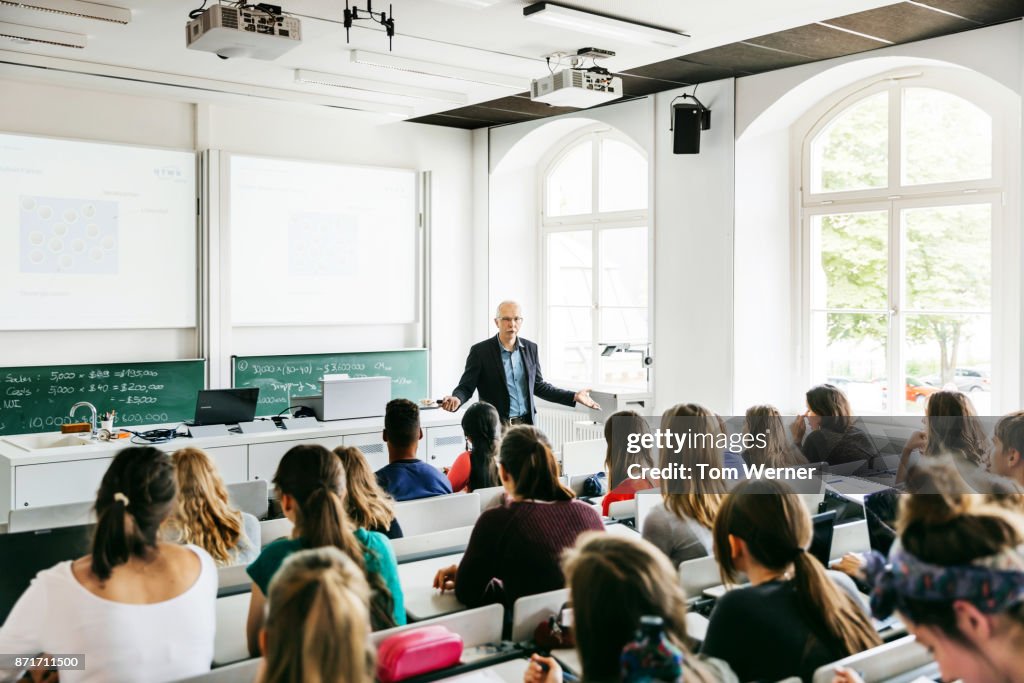 University Professor Addressing His Pupils During Lecture
