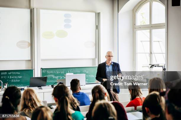 university lecturer addressing his students - male professor with students stock pictures, royalty-free photos & images