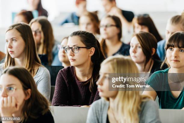 university students attending lecture - college stock-fotos und bilder