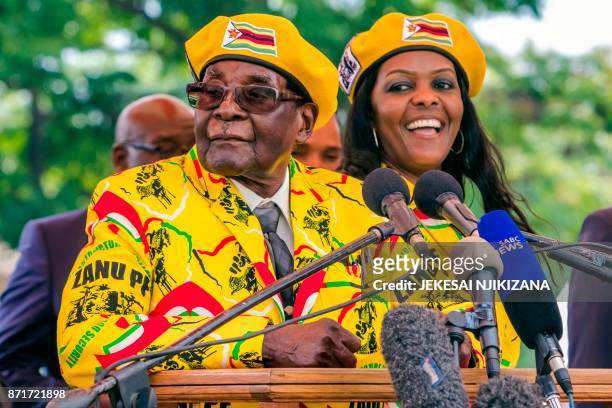 Zimbabwe's President Robert Mugabe addresses party members and supporters gathered at his party headquarters to show support to Grace Mugabe becoming...